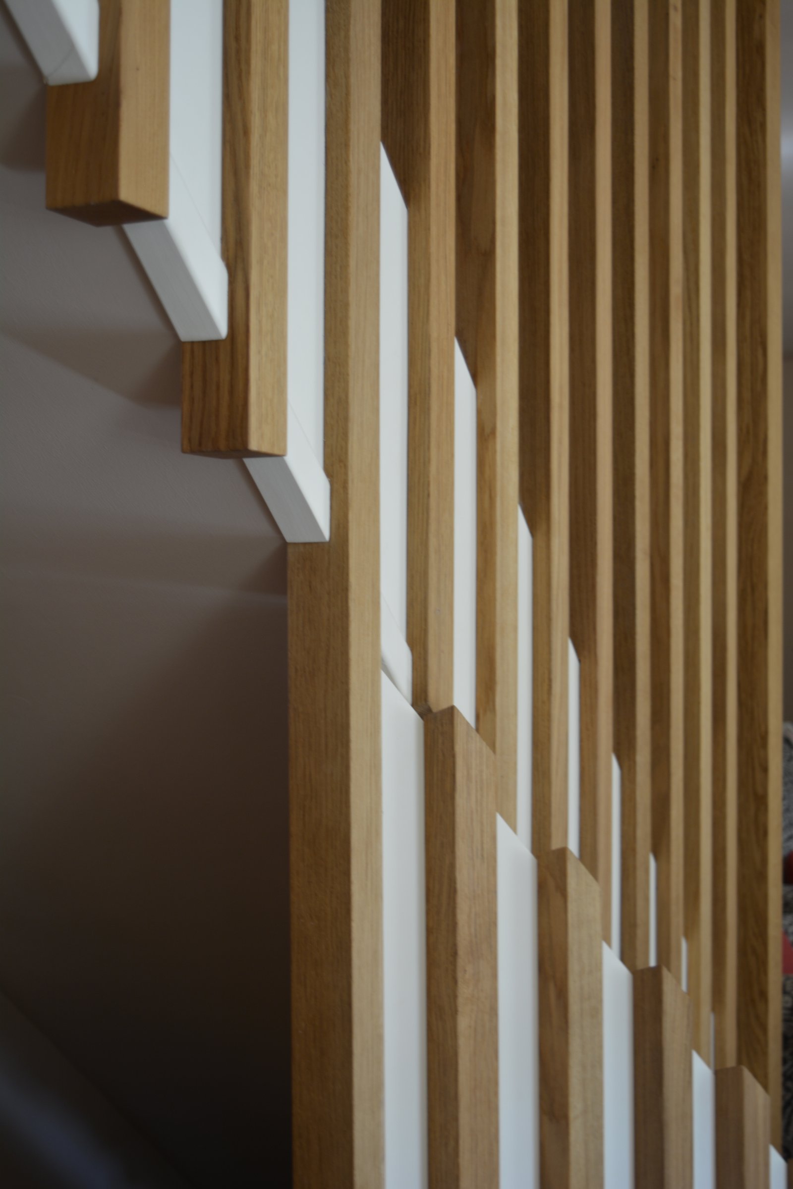 Layered timber and painted joinery components showing precise detailing
