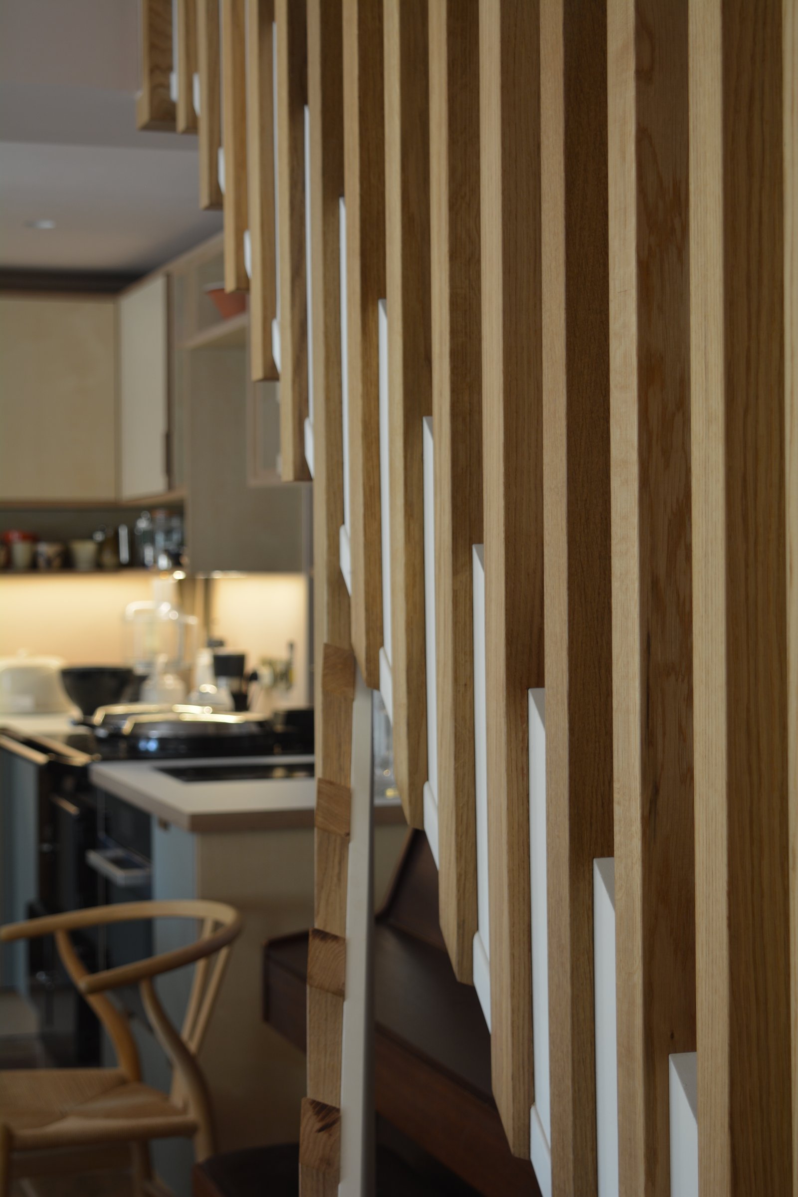Close-up bespoke timber joinery detail with layered rails and shelving